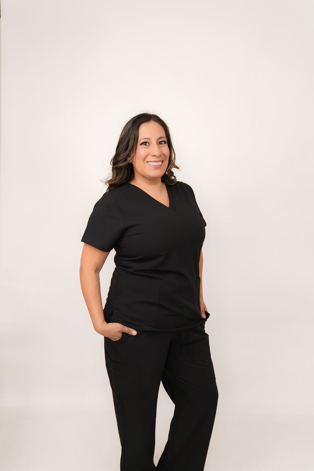 Stephanie Garcia, RDH, OMT, MS, smiling in black scrubs