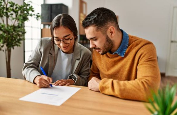A single, authentic photo of a mortgage advisor consulting with diverse homebuyers, focusing on affordability and budgeting, in a welcoming, modern setting. A single, authentic photo of a mortgage advisor consulting with diverse homebuyers, focusing on affordability and budgeting, in a welcoming, modern setting.