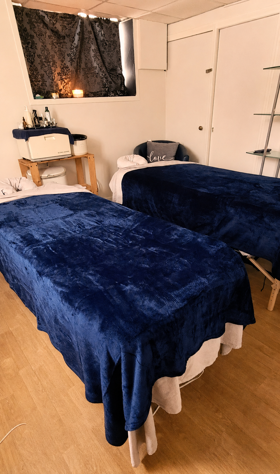 Two massage tables prepared for a couples treatment at Fundamentals Relaxation Spa