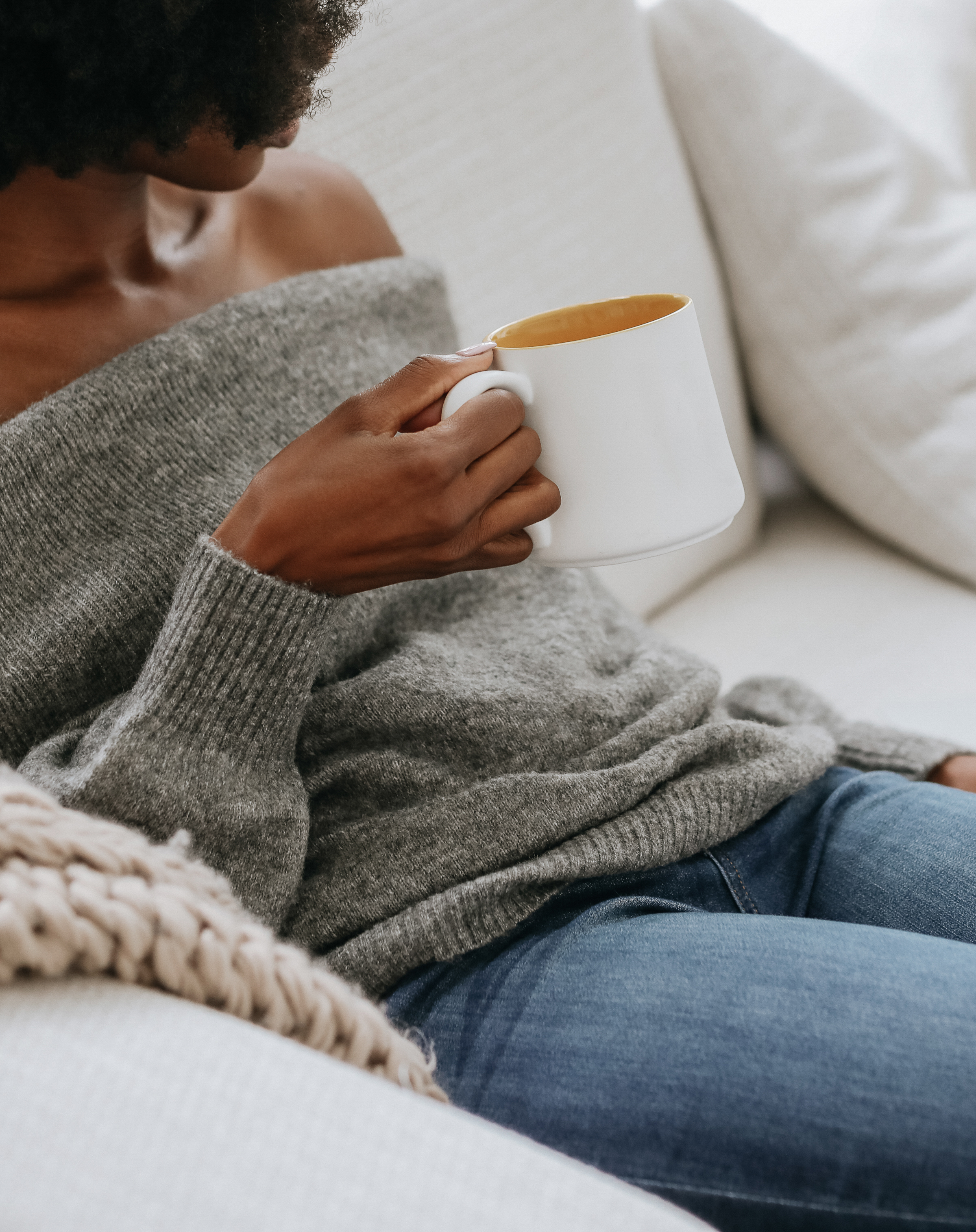 Woman relaxing at home with a warm drink