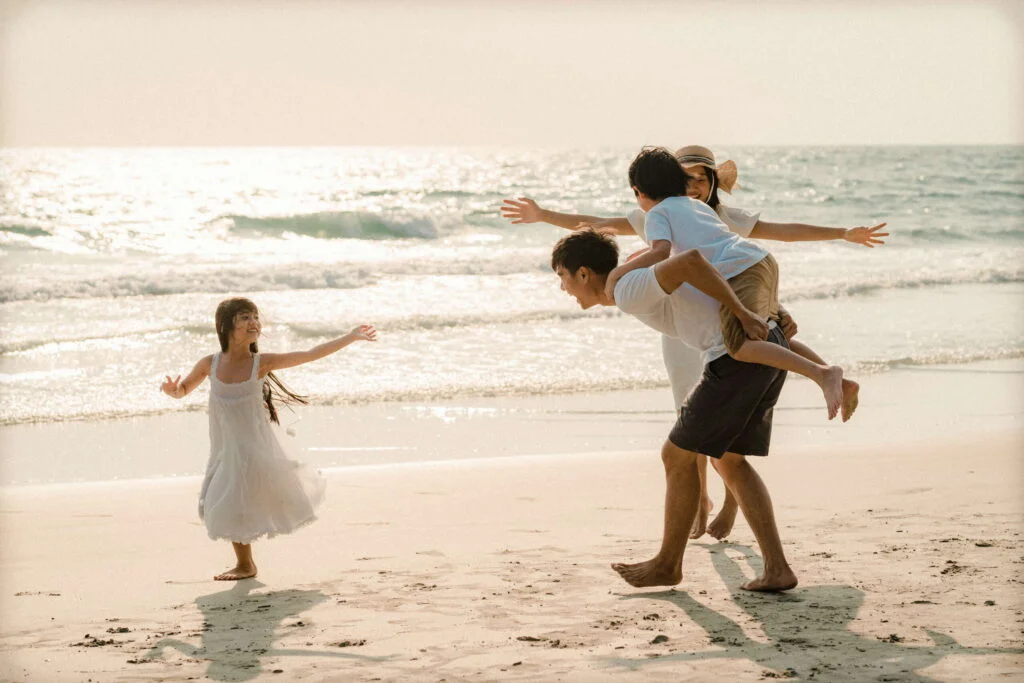 Family enjoying the beach together — BioKissed wellness lifestyle