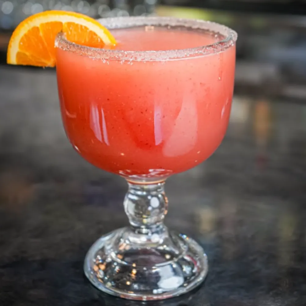 El Tapatio strawberry margarita with orange wedge