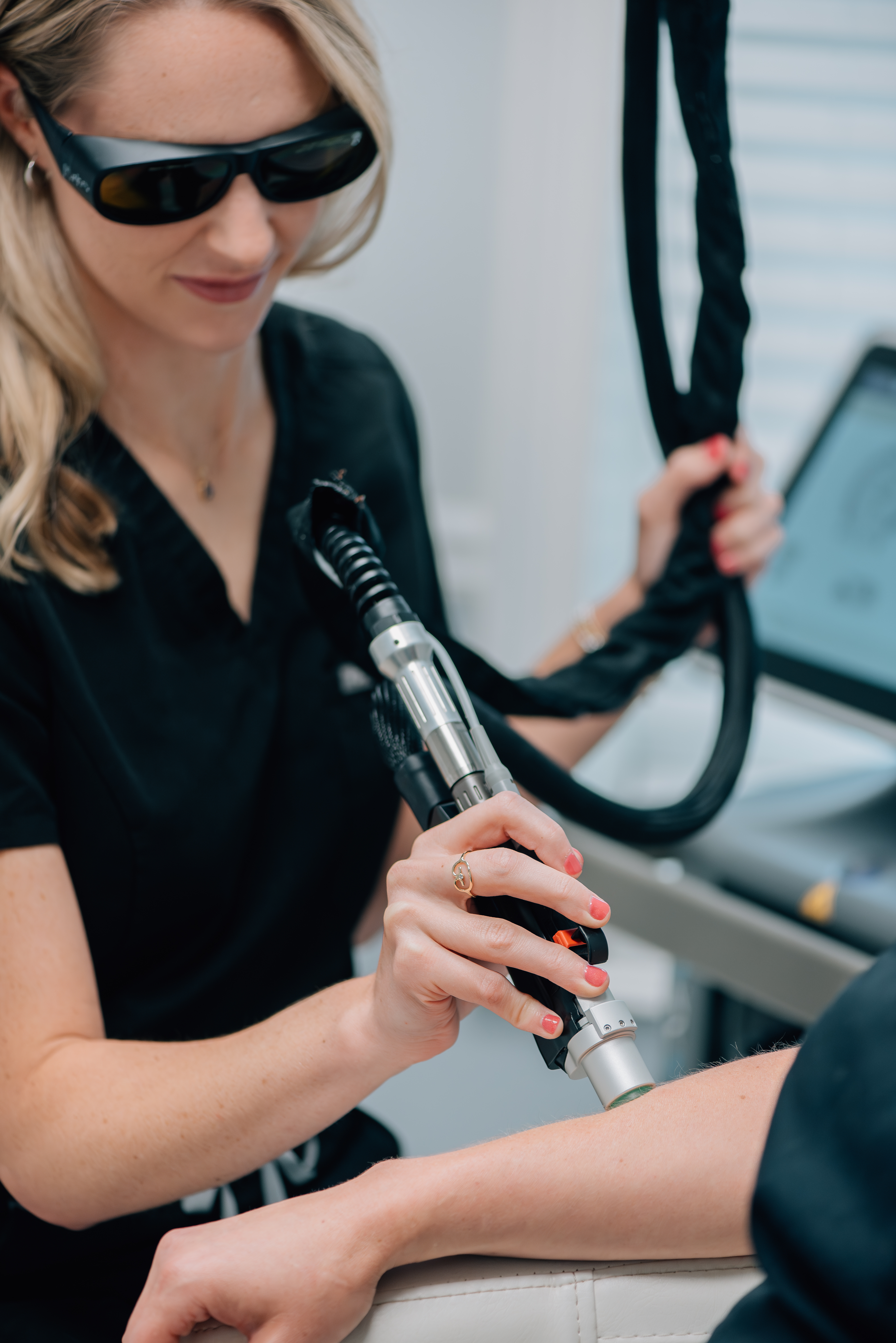 MOTUS AZ+ Moveo laser handpiece applied to patient's arm during hair removal treatment
