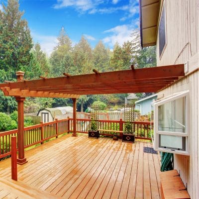 Spacious wooden pergola over a backyard deck