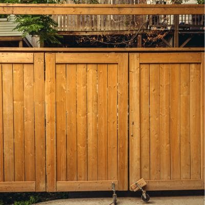 Sturdy wooden privacy fence with vertical panels and a smooth finish