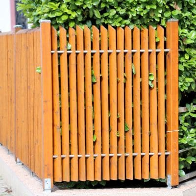 Stylish wooden privacy fence with vertical slats and metal accents