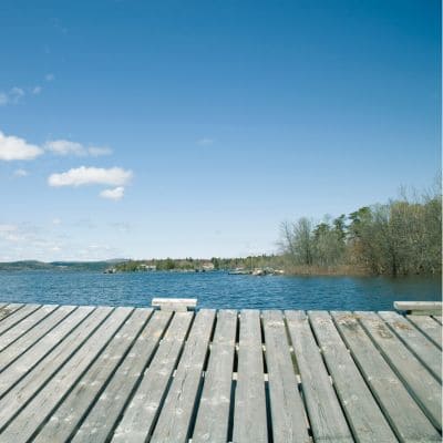 Large wooden deck overlooking a serene lake