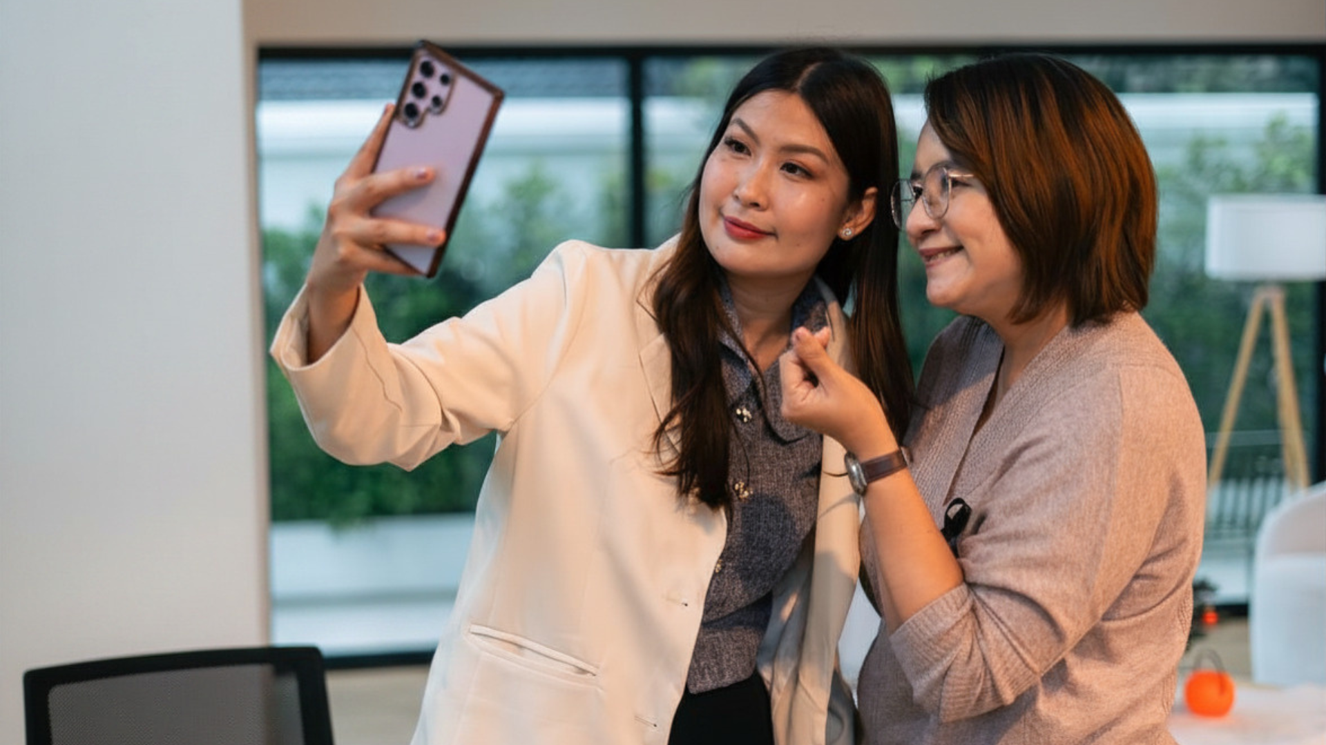 Two people taking a selfie together at a networking event Two people taking a selfie together at a networking event