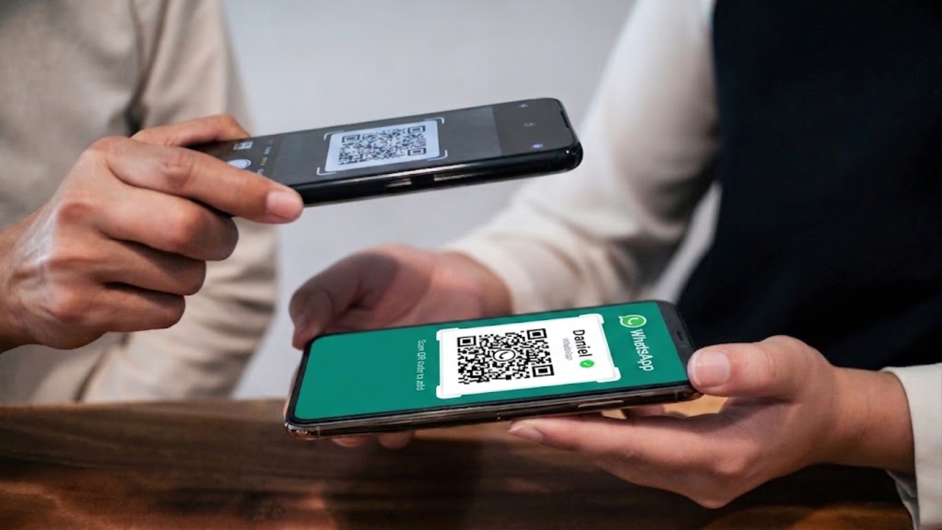 Exchanging WhatsApp contact details using a QR code at a networking event Exchanging WhatsApp contact details using a QR code at a networking event