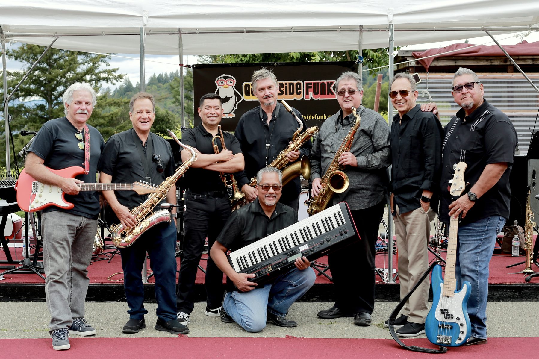 Official East Side Funk band photo — all eight members with their instruments