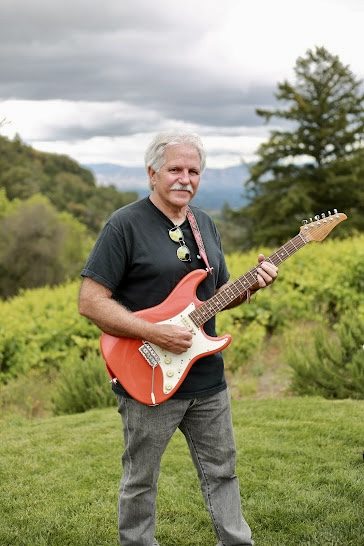 Les Thomas with his electric guitar