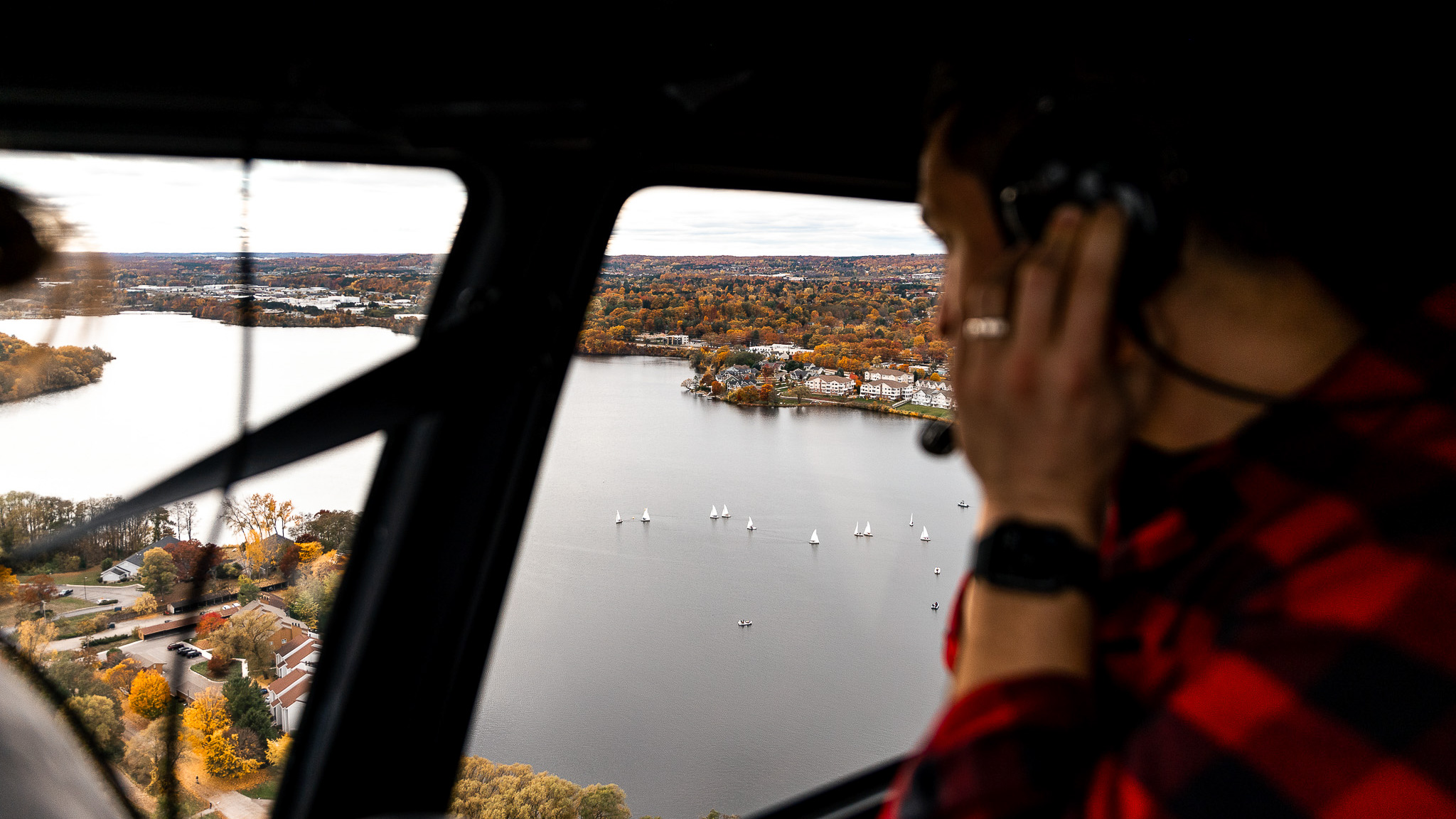  Experiencing a helicopter ride in Traverse City, Michigan, amidst the captivating beauty of the fall season.