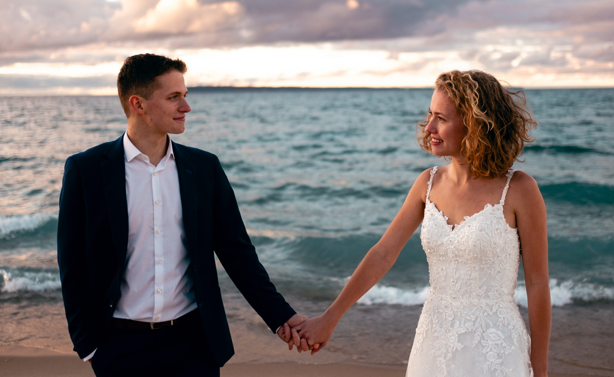 Josh and Siena by Lake Michigan in their wedding attire.