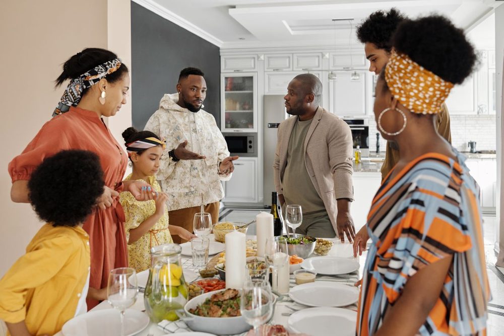 Family cooking and sharing a meal together in the kitchen