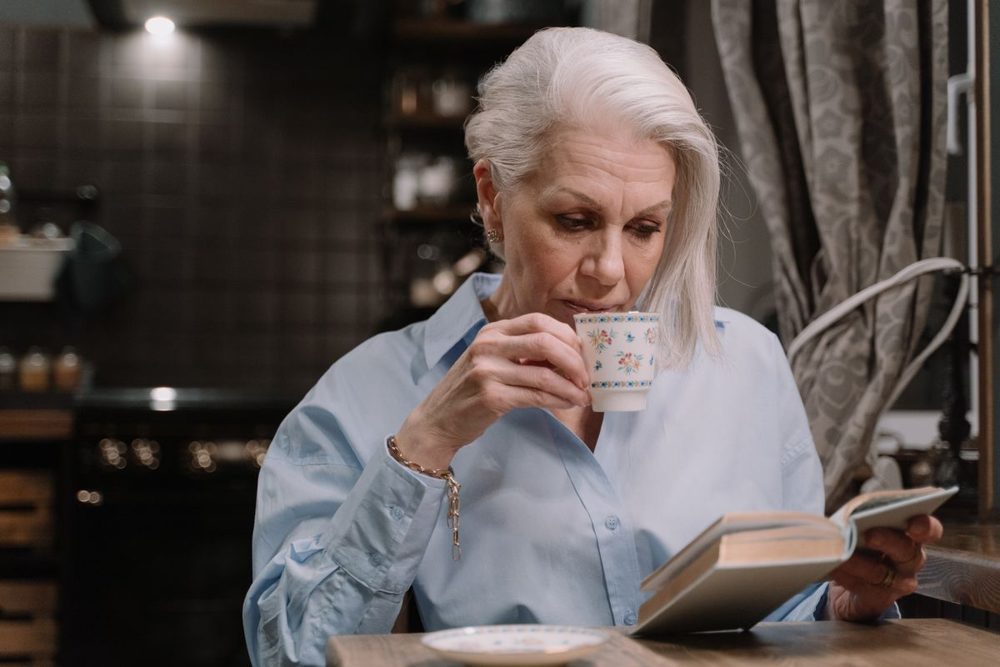 Person resting comfortably with a warm cup of tea
