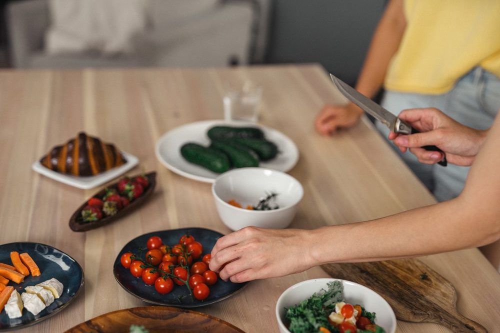 Woman preparing a healthy meal with fresh whole foods at home