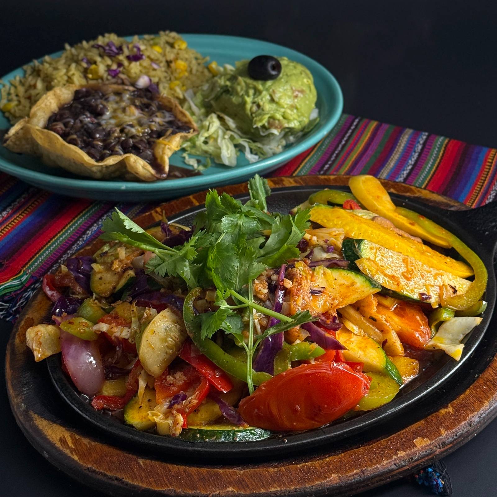 Vegetarian Fiesta Fajitas: a skillet of grilled zucchini, squash, peppers, tomato and red onion with a side plate of black beans and guacamole at Casa de Bandini, Carlsbad