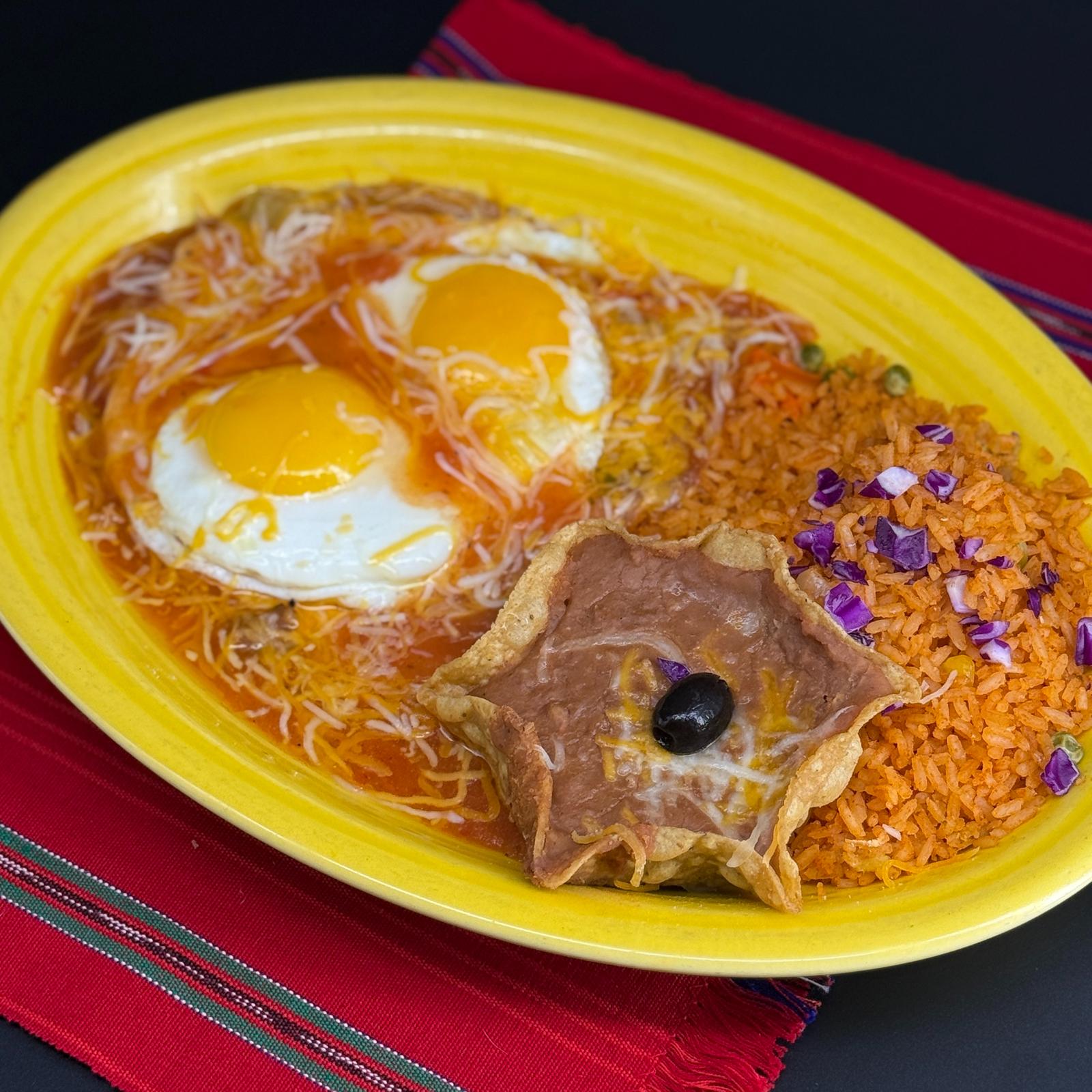 Classic Huevos Rancheros with two sunny-side-up eggs in salsa española and melted cheese, Mexican rice and refried beans in a crispy tortilla cup at Casa de Bandini, Carlsbad