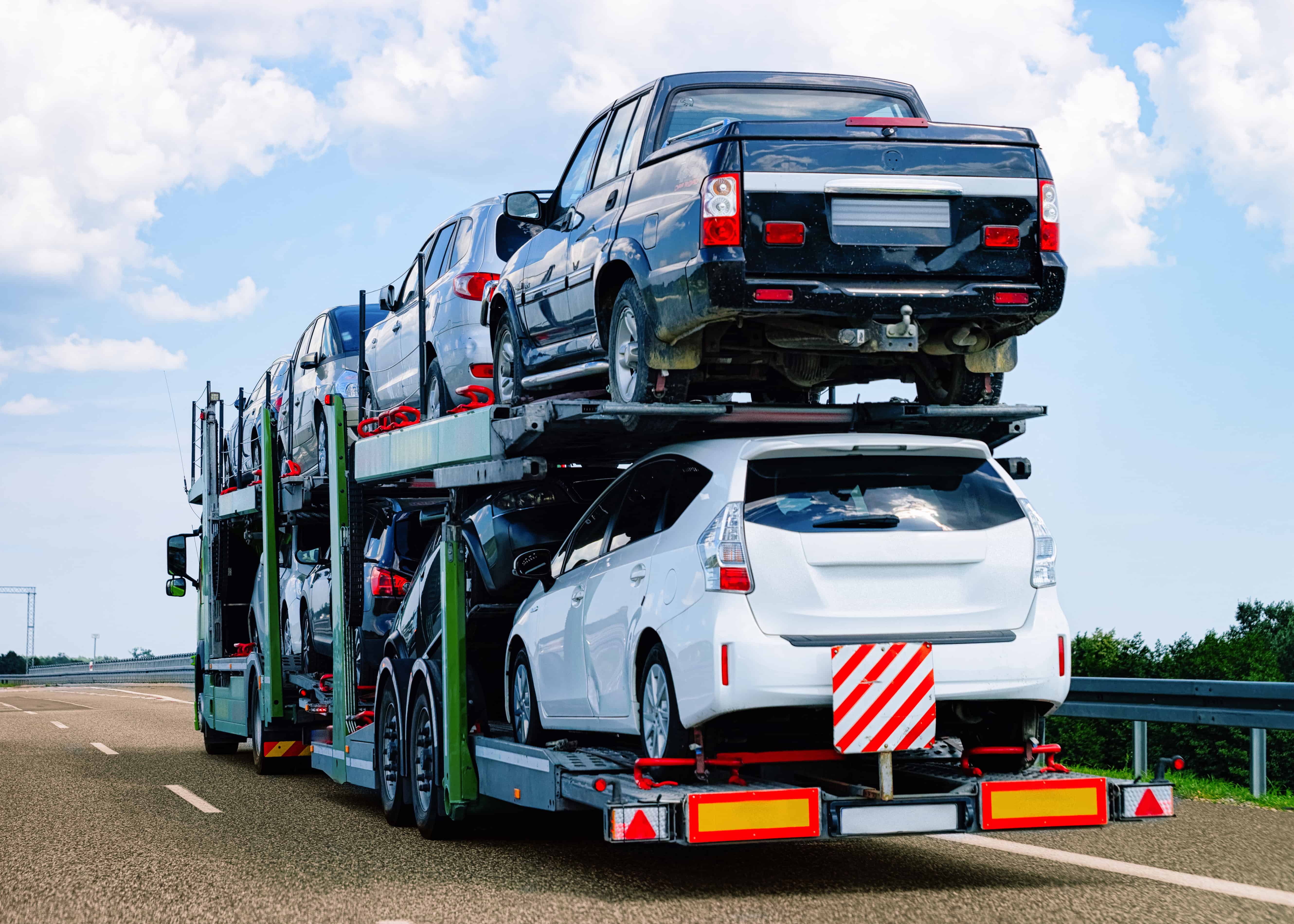 Tow truck transporting many vehicles