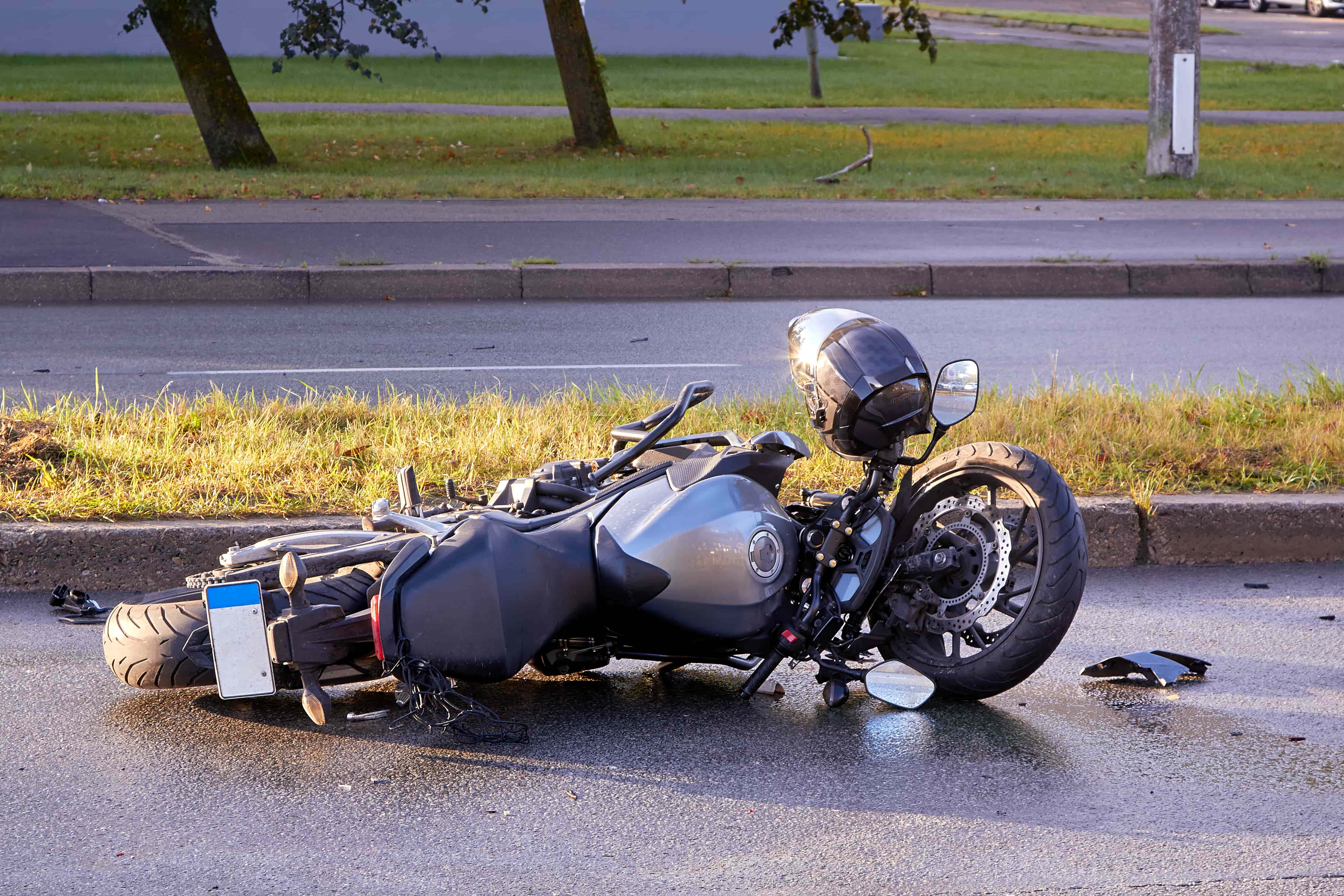 Motorcycle on the road on its side 
