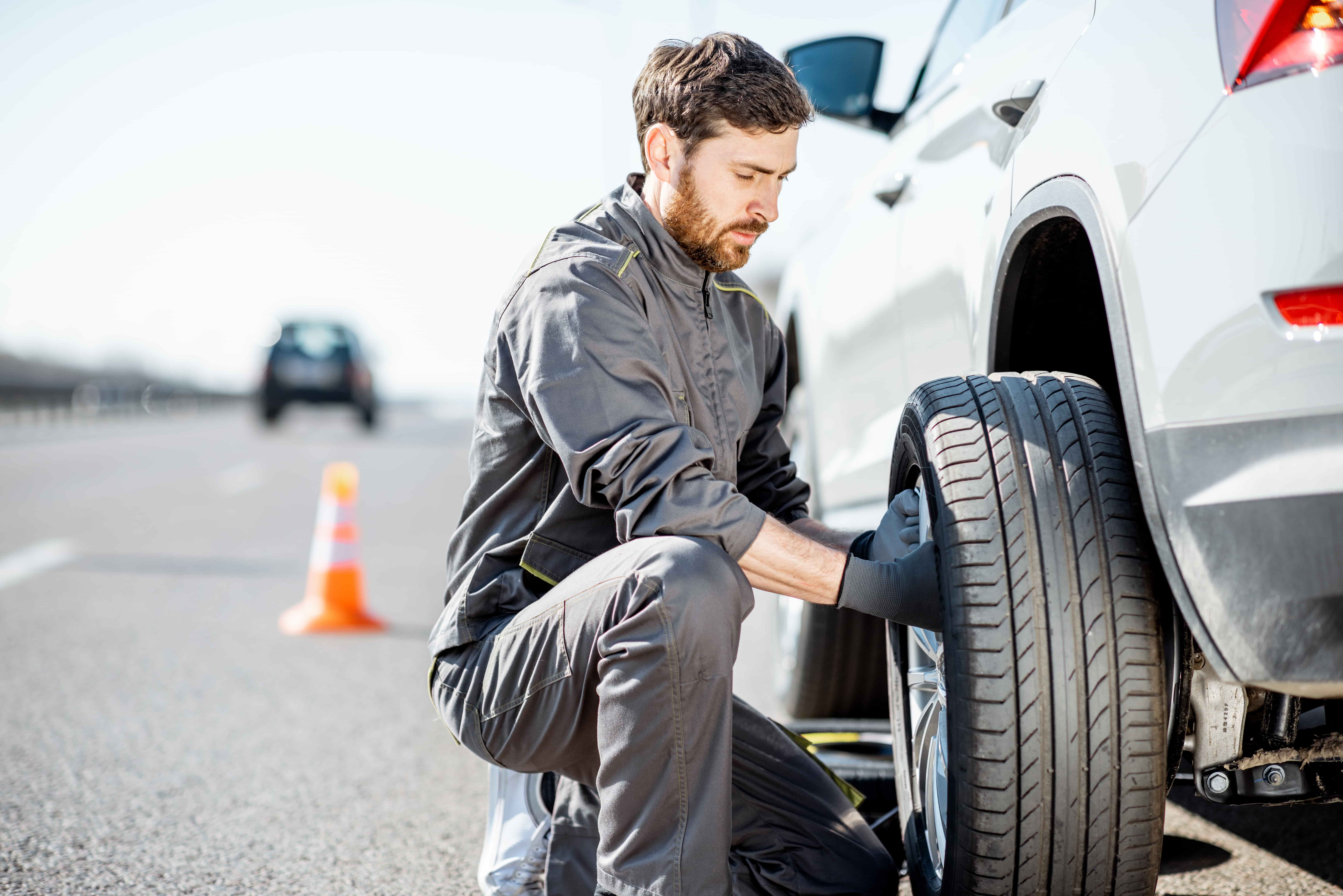 male technician changing a tire