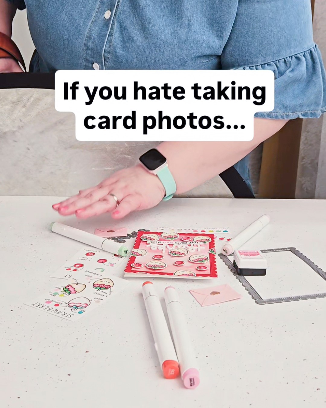 crafter sorting markers and stamps on a busy desk setup