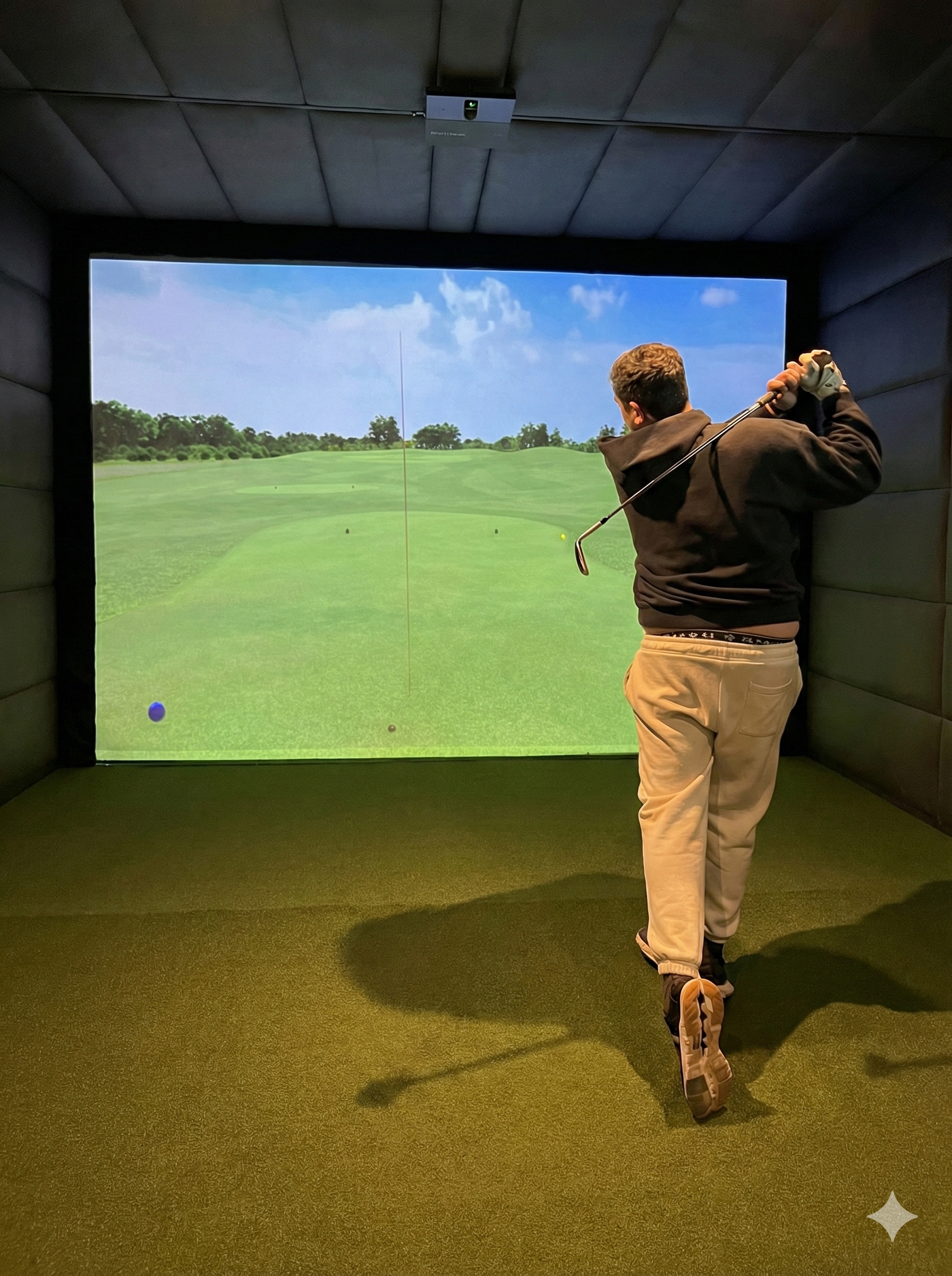 Player mid-swing in Eagle Bay Golf Sims bay