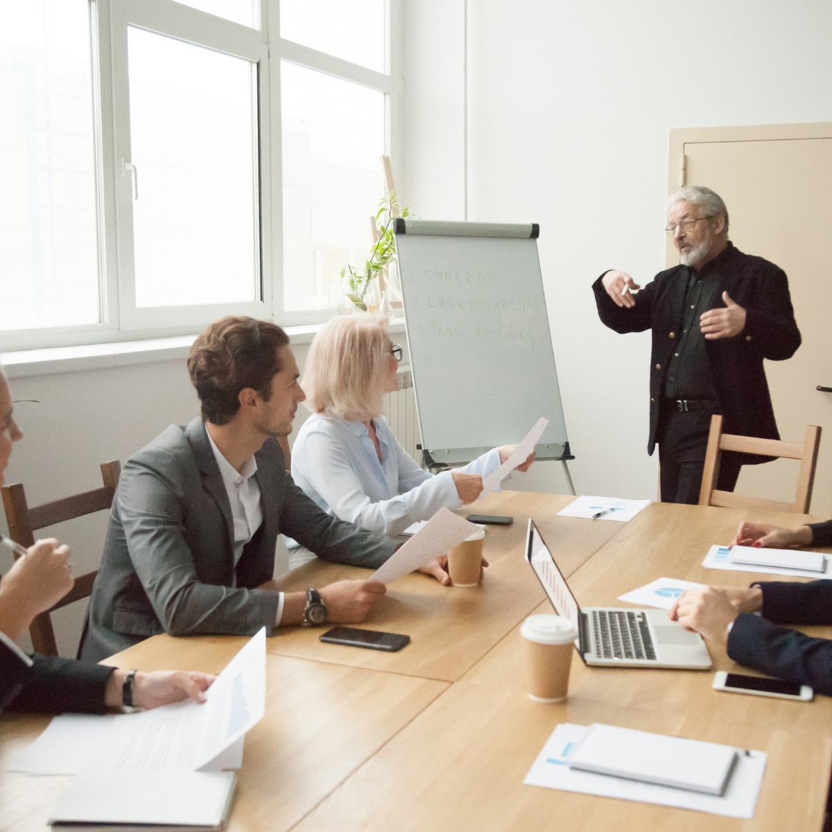 Team brainstorming with notes on a board.