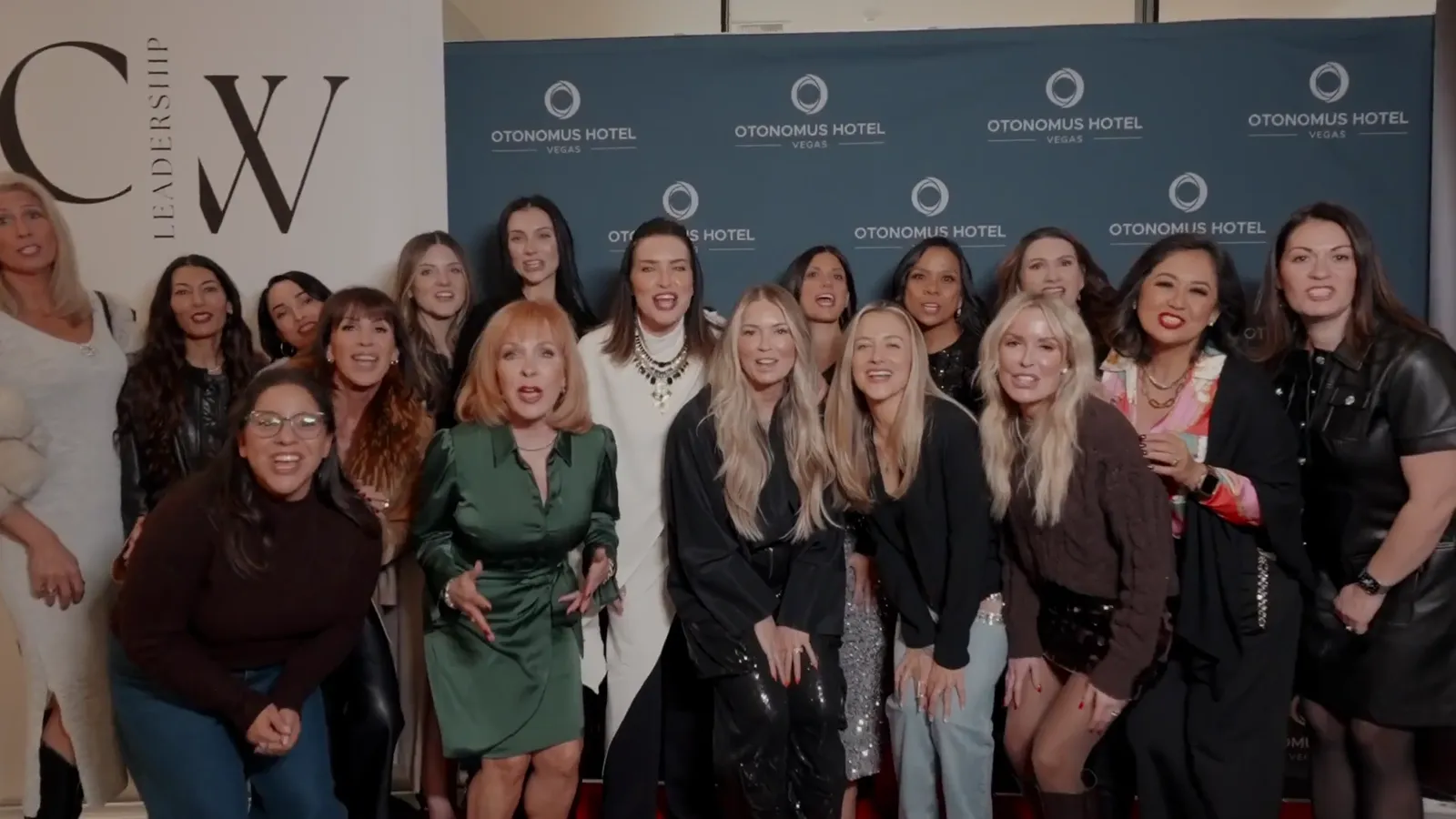 Four CWL members standing together in front of the Collective Women's Leadership backdrop