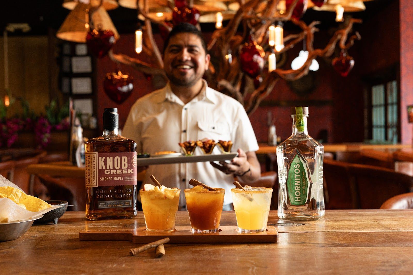 Bartender pouring cocktails at Emiliano's Mexican Table, photographed by Hybrid Storytellers