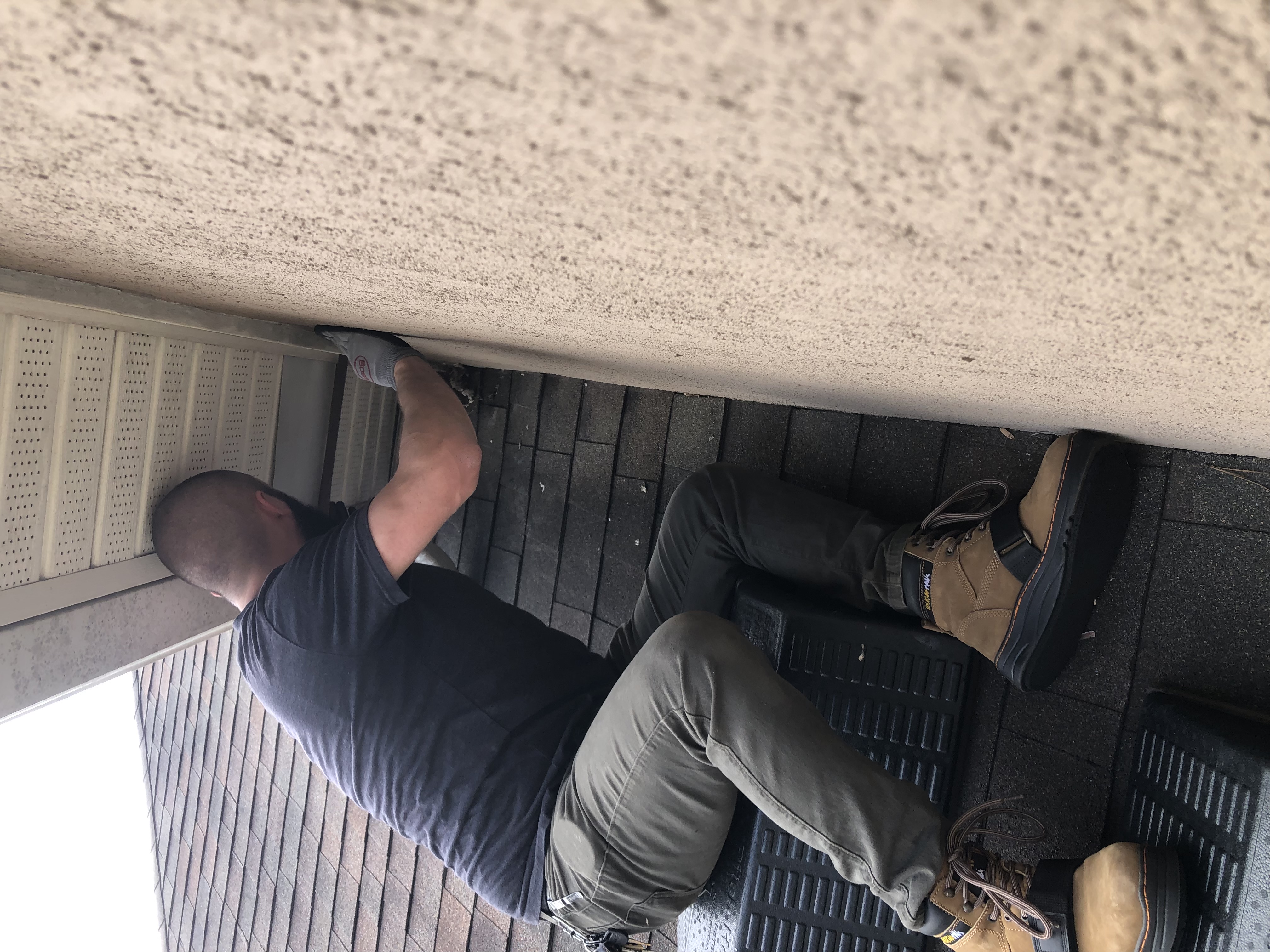 Michael Pope sealing a soffit gap on an Atlanta home