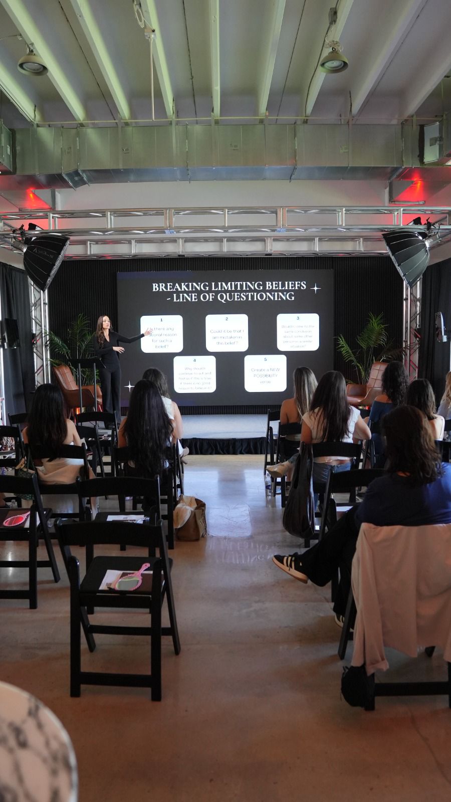 Liz Kennedy on stage — Breaking Limiting Beliefs seminar