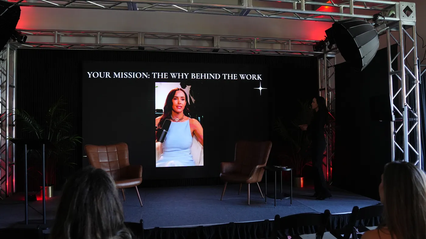 Liz Kennedy on stage speaking about soul mission