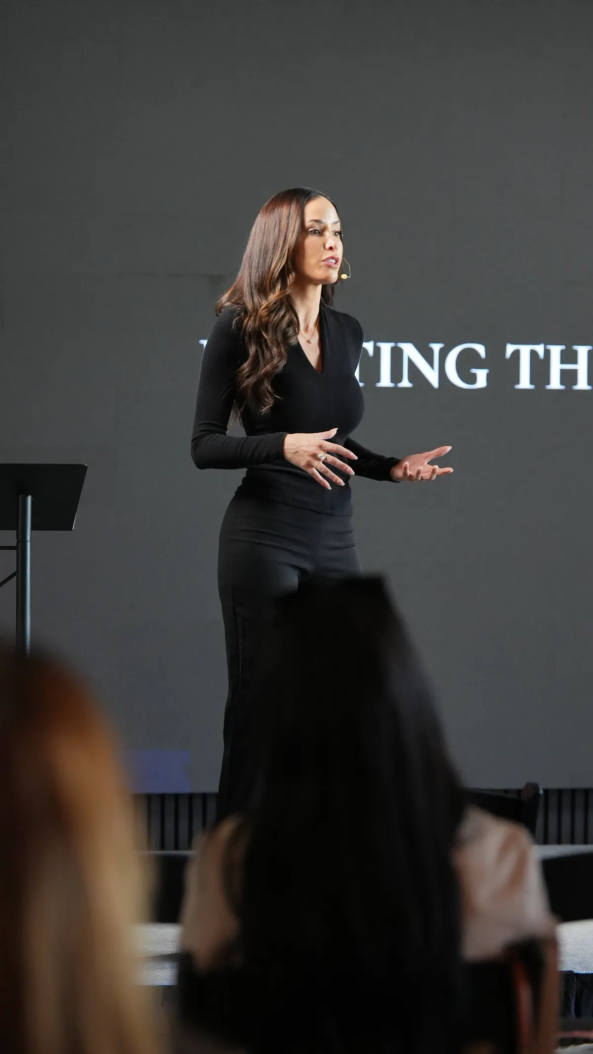 Liz Kennedy speaking close-up with headset microphone
