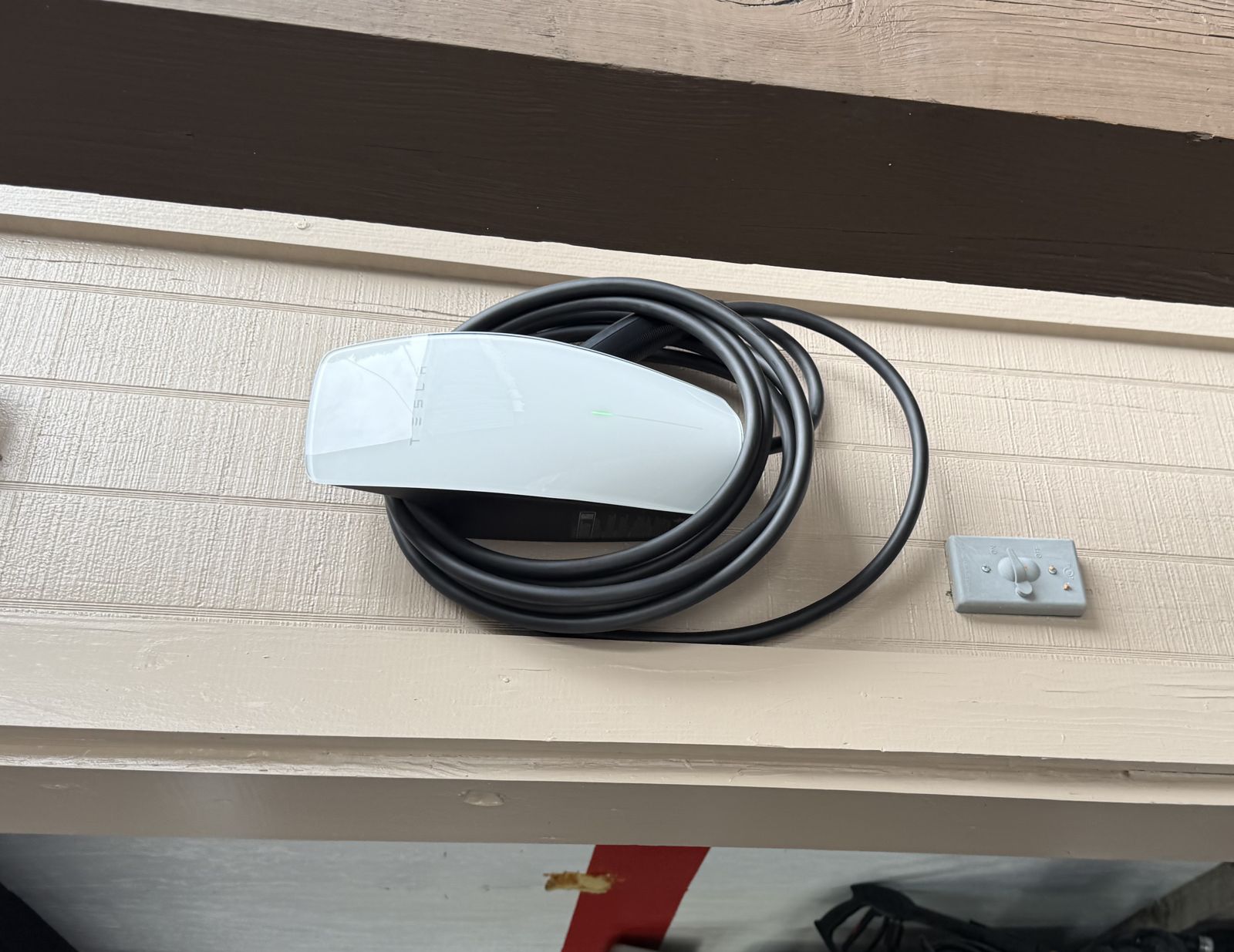 Tesla Wall Connector installed under the eave of a Houston garage by RBG Services LLC