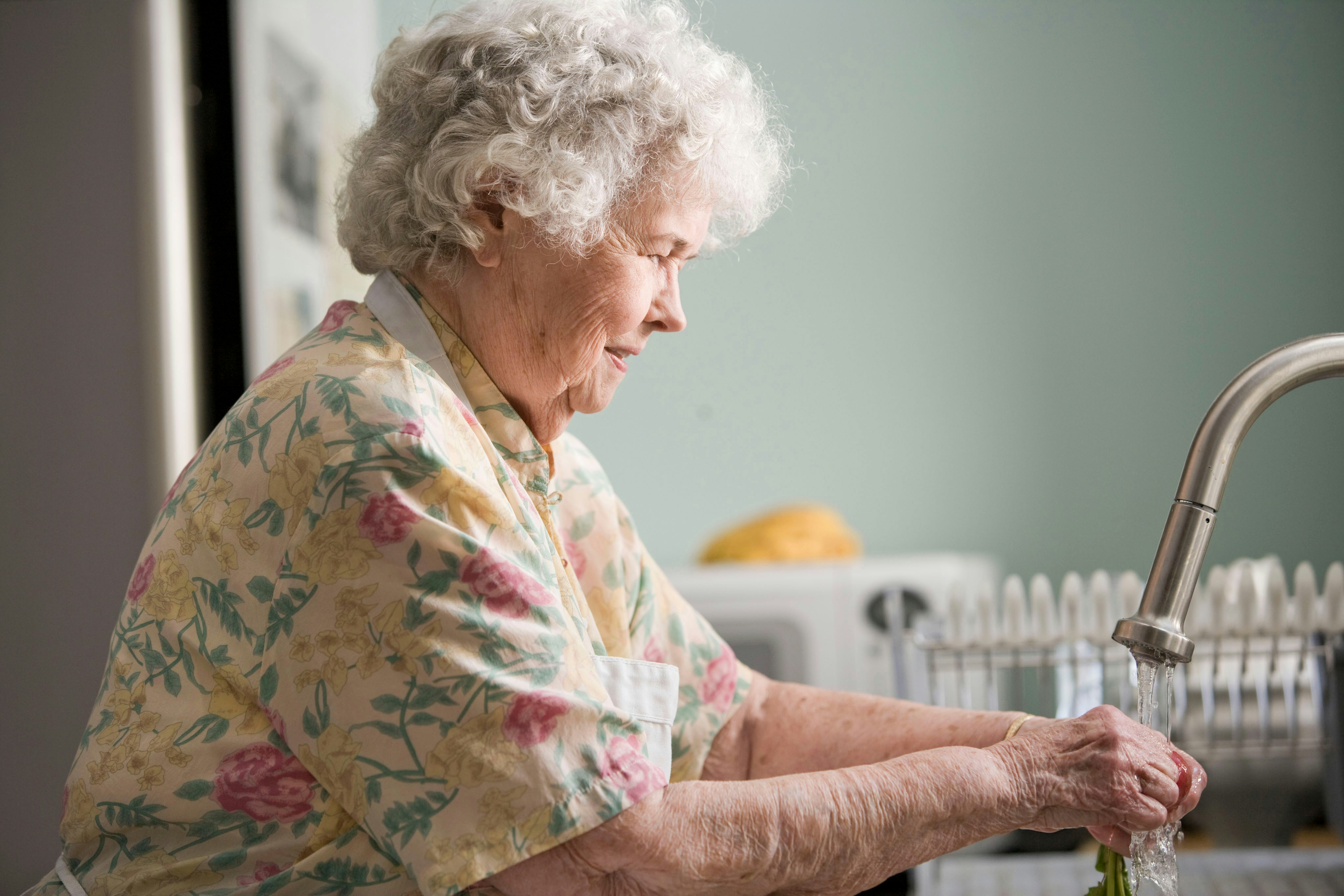Elderly woman washing hands Elderly woman washing hands