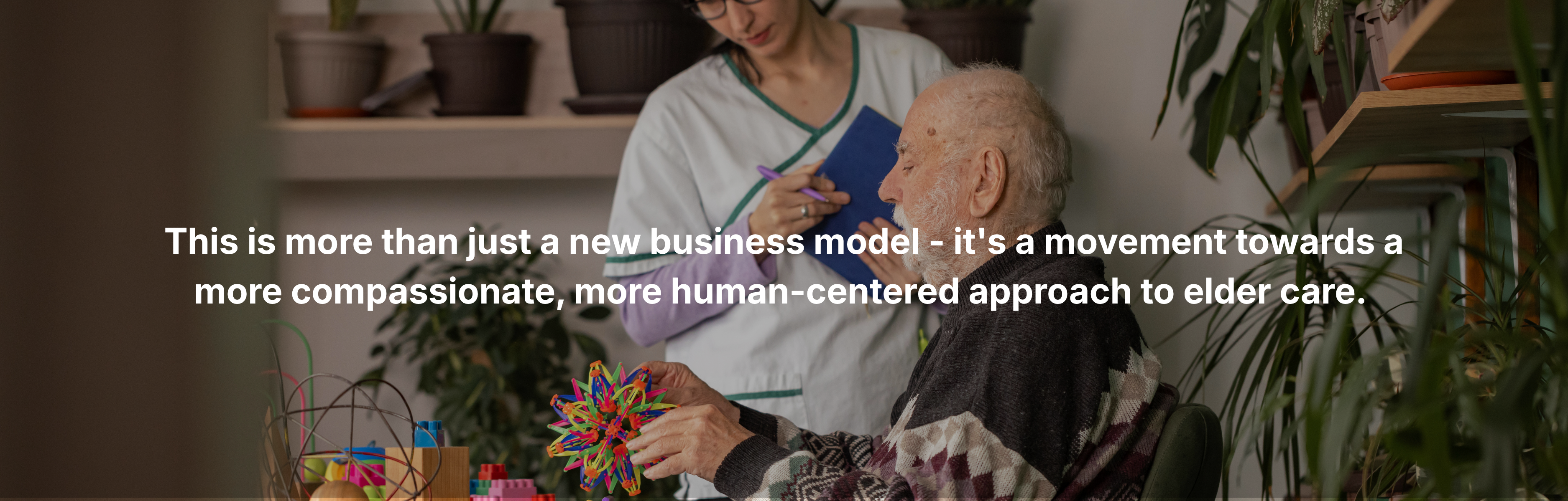Caregiver assisting an elderly man during a cognitive activity at home, representing compassionate, human-centered elder care