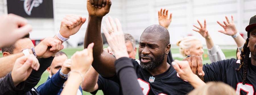 Ovie Mughelli greeting fans on the practice field
