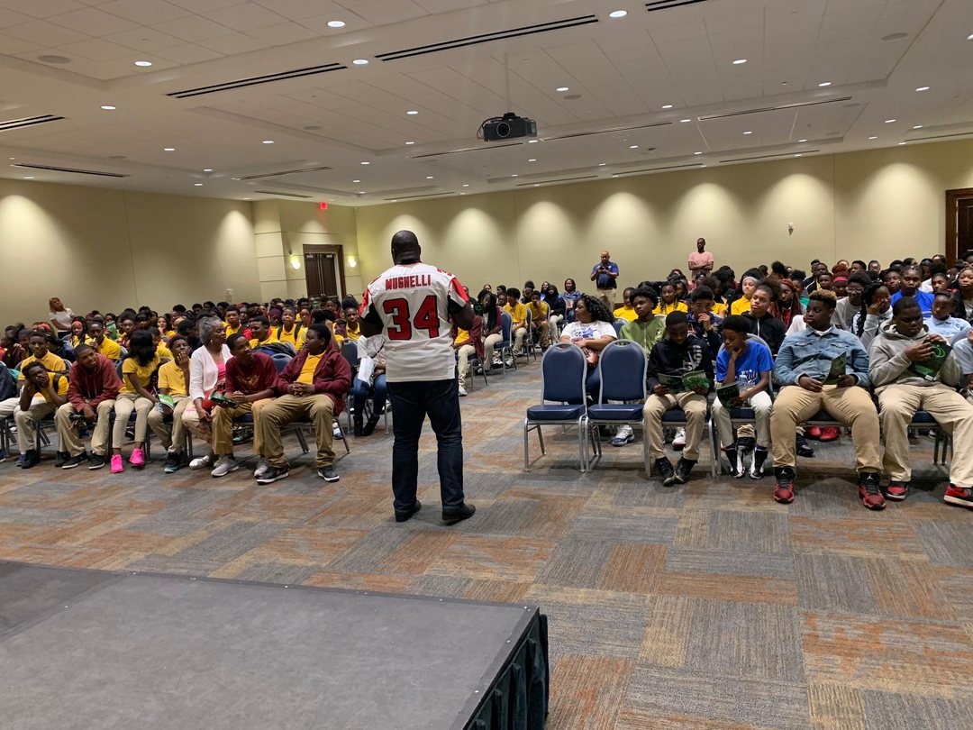 Ovie Mughelli speaking to a seated audience