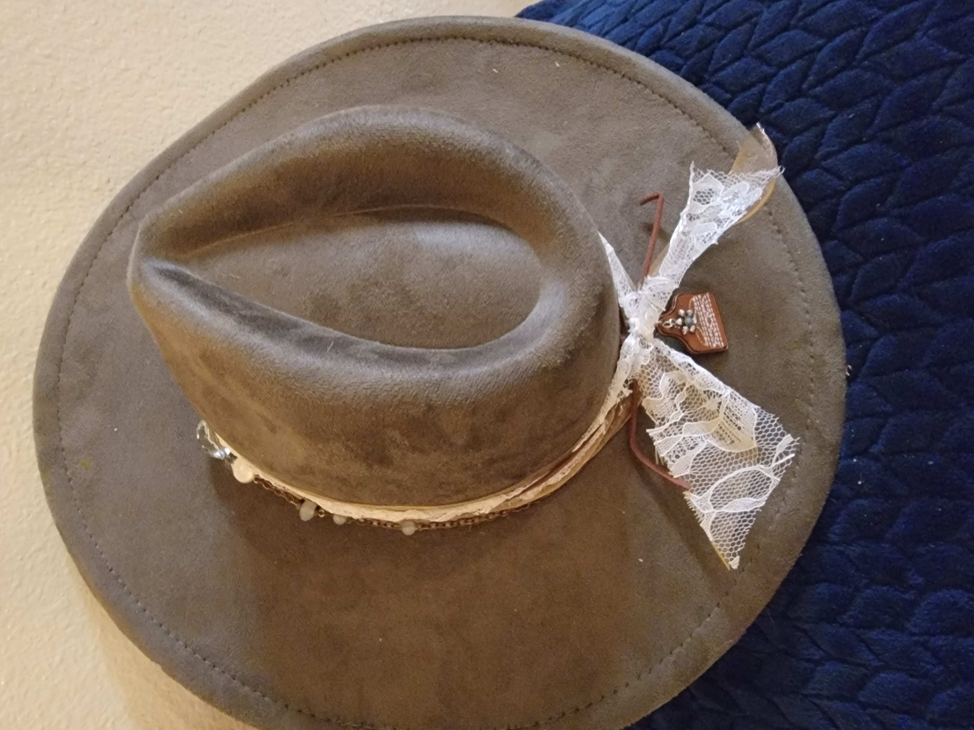 Taupe suede fedora with a lace band and charm