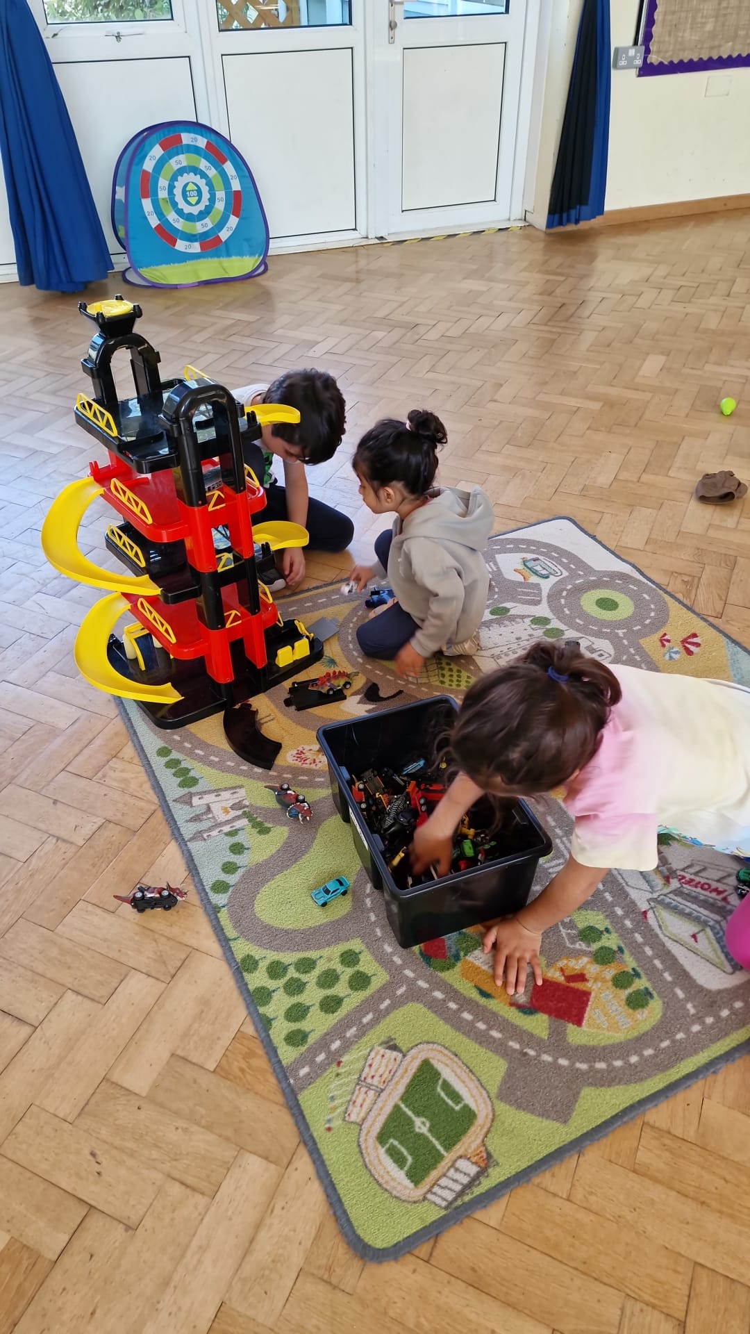 Toddler and parent using a mini Swiss ball at a Mad4Sports pre-school class