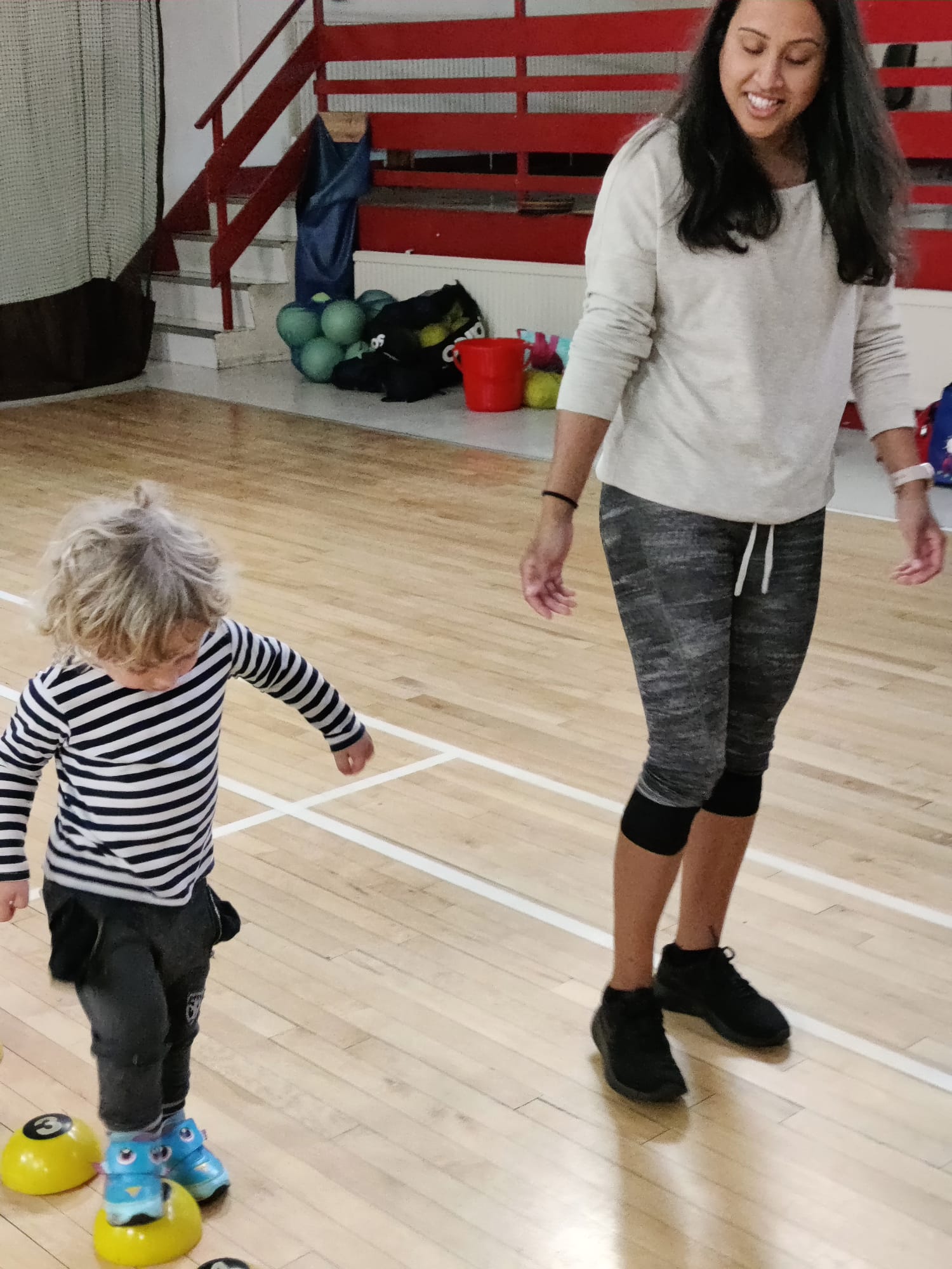 Young child learning basic ball skills through games at a Mad4Sports pre-school class