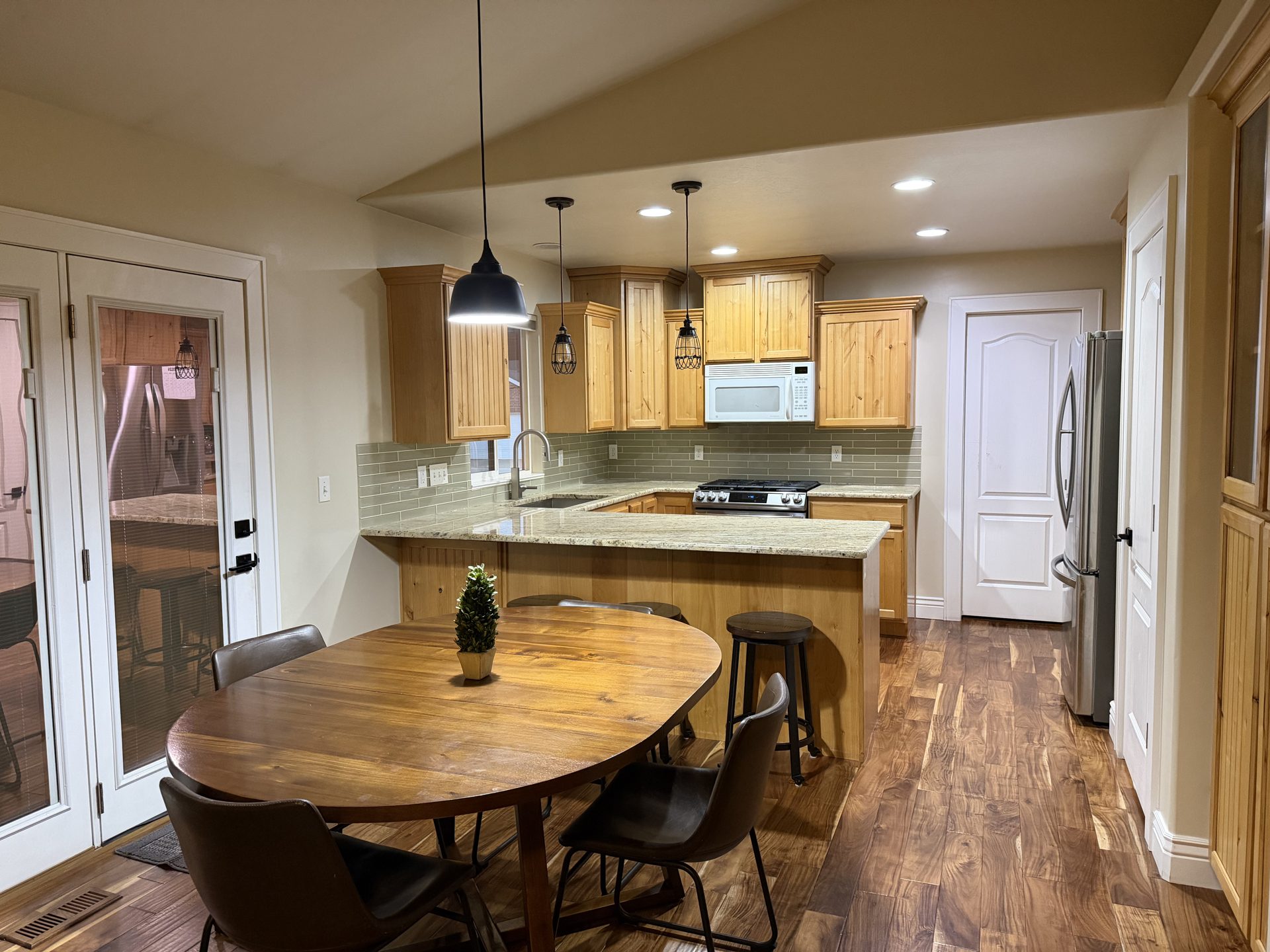 Kitchen with granite counters, knotty alder cabinets, and dining nook