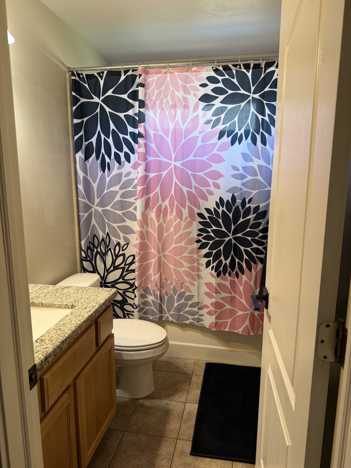 Fully tiled bathroom with granite counters