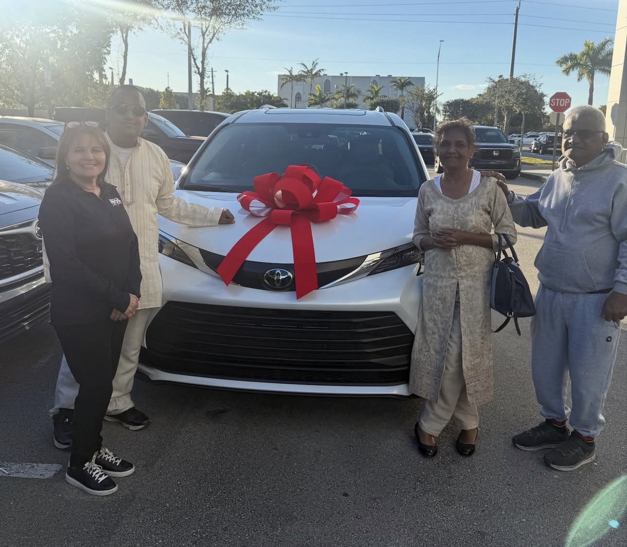 Sandra with happy client and their new Toyota