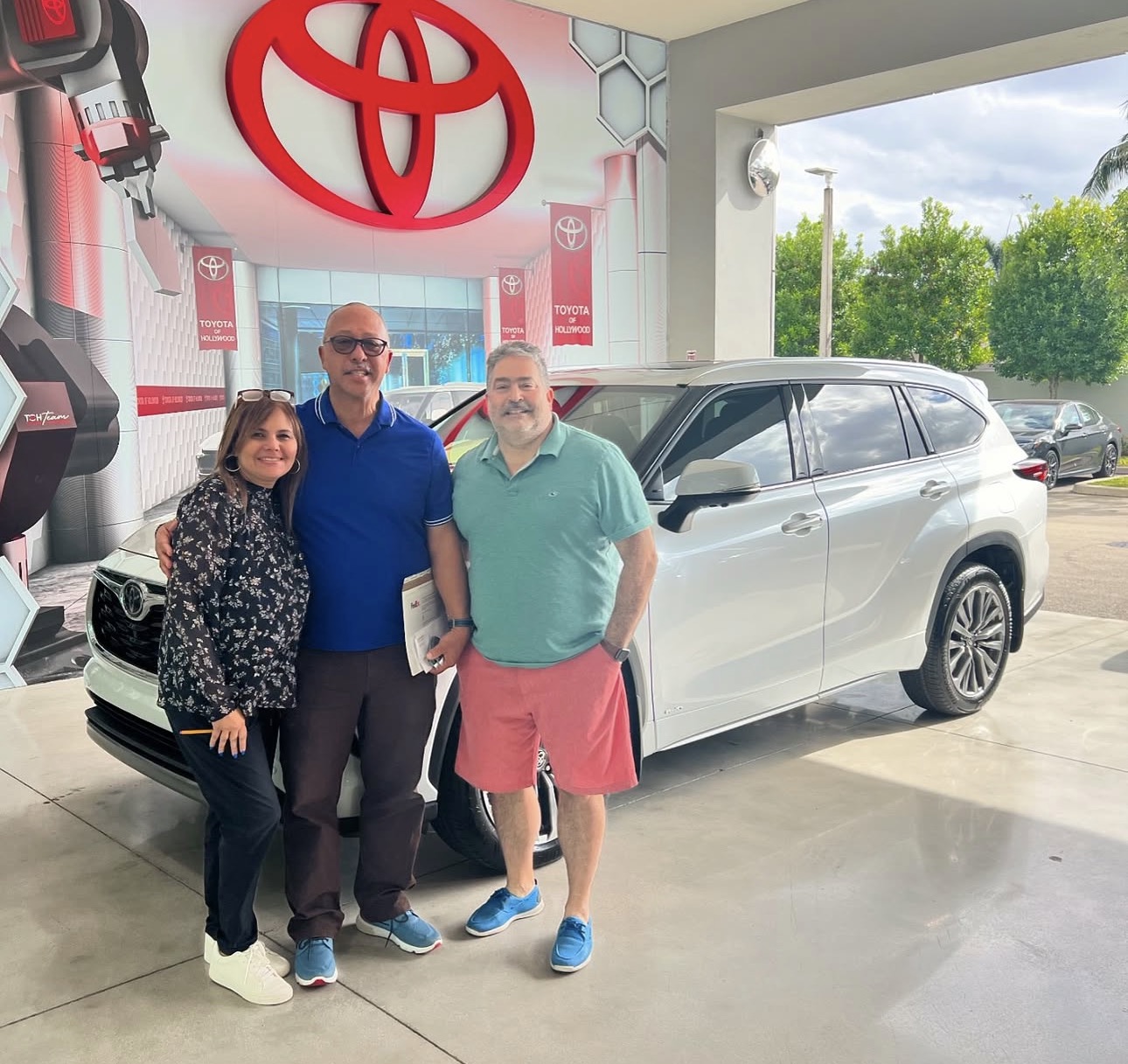 Sandra with happy client and their new Toyota