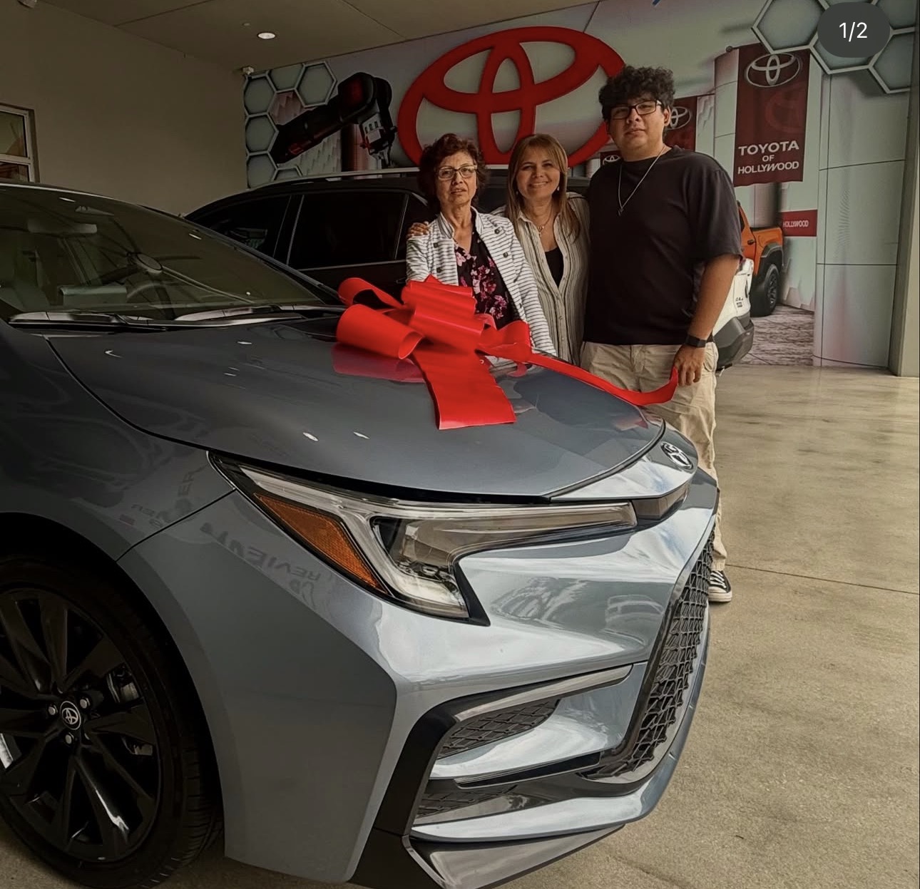 Sandra with happy client and their new Toyota