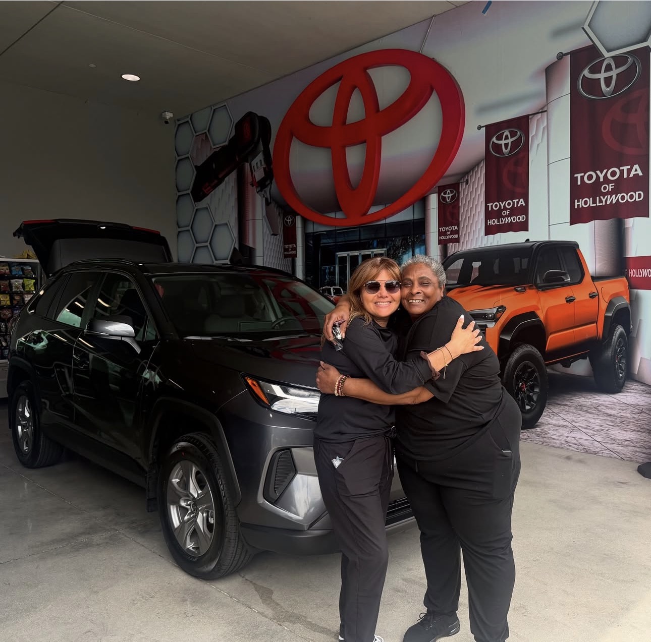 Sandra with happy client and their new Toyota