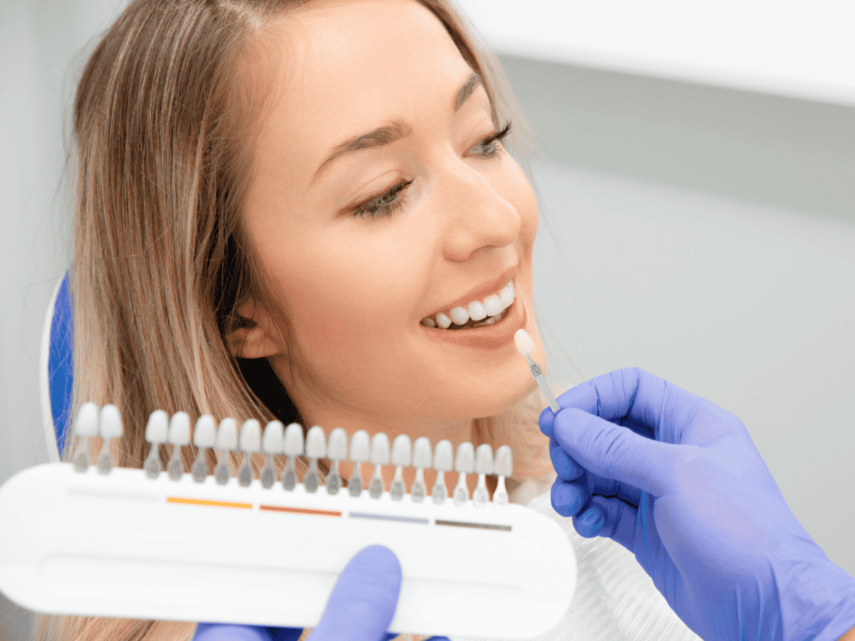 Close-up of thin veneer positioned over natural tooth Close-up of thin veneer positioned over natural tooth