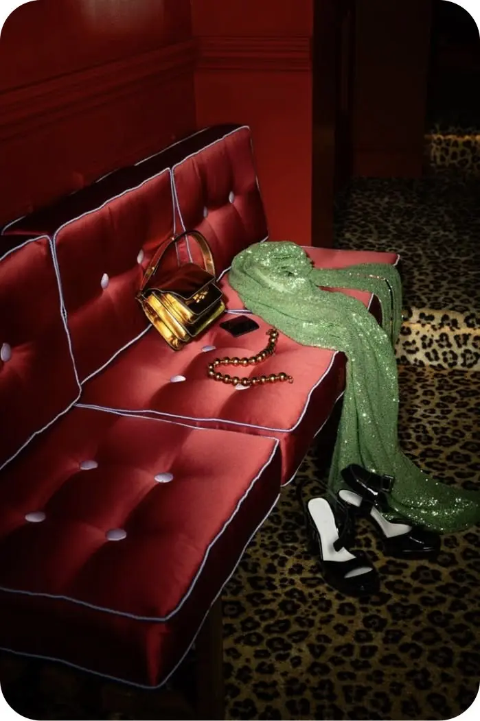 Guests on a velvet couch, half in shadow